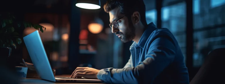 a person sitting at a desk with a computer and a notebook, deep in thought while working on a persuasive copywriting project.