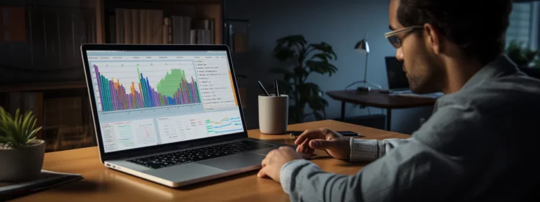 a person sitting at a desk with a laptop and notepad, surrounded by charts and graphs as they analyze data for their seo strategy.