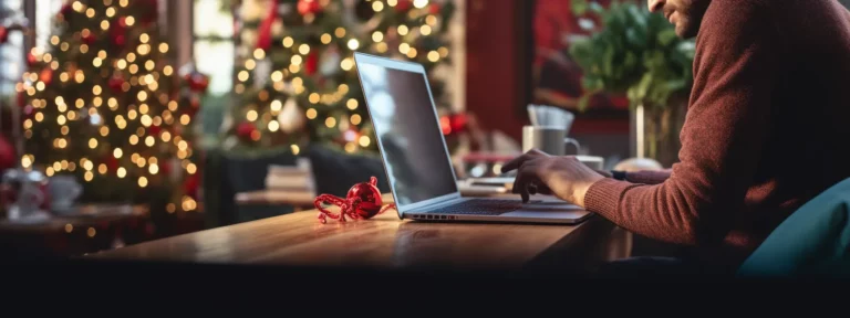 a person working on a laptop with holiday-themed decorations in the background.